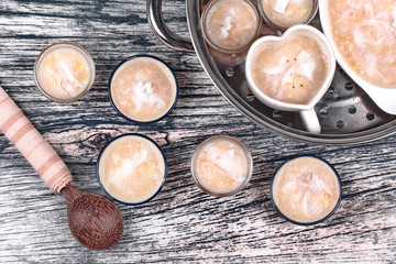 Streamed sweet banana dessert topped coconut roll .