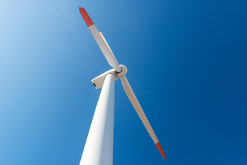 Wind turbines  against a blue sky generating electricity