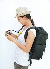 Portrait of young girl traveler with camera isolated on white background
