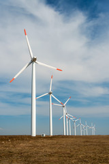 Wind turbines  against a blue sky generating electricity