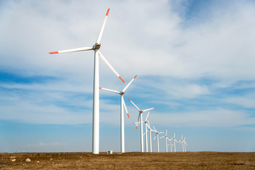 Wind turbines  against a blue sky generating electricity