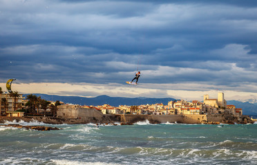 Fototapeta na wymiar kitesufer flying high over the city
