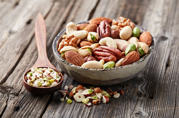 Mix nuts on a wooden background. Cut nuts