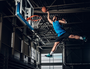  Black basketball player in action in a basketball court.