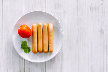 Sausages on a wooden background