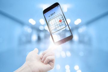 Transparent smart phone with calendar screen on hand