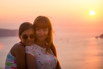 Mother and daughter at sunset. 