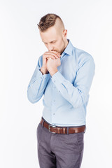 bearded business man praying with hands. human emotion expression and lifestyle concept. image on a white studio background..