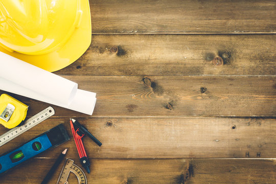 Construction tools  with helmet safety on wooden background