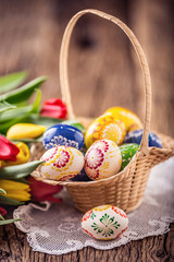Obraz na płótnie Canvas Easter. Hand made painted easter eggs in basket and spring tulips.