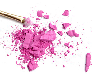 Close up of crushed blush on white background and cosmetic brush