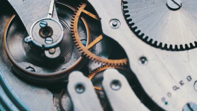 Old vintage clock mechanism working, closeup shot with soft focus