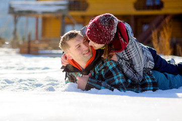 Young couple lies on the snow.