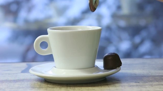 Hand Stirring Steaming Cup of Black Coffee.