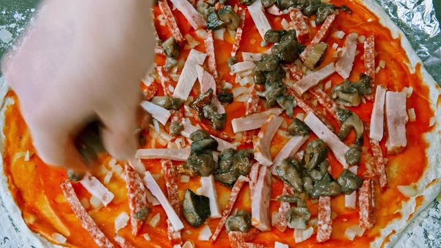 preparing the pizza for baking.