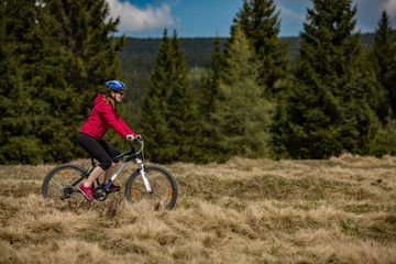 Fototapeta premium Middle-aged woman riding bicycle