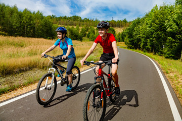 Fototapeta na wymiar Teenage girl and boy cycling