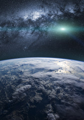 A fantasy view of the planet Earth with the milky way in background, and shiny stars in the sky. Elements of this image furnished by NASA. © Maxal Tamor