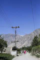 Walking local woman on the road. Karimabad Hunza valley. Pakistan 