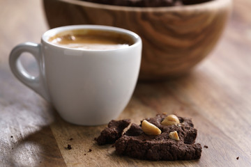 cup of fresh espresso with homemade chocolate cookie with hazelnuts, shallow focus