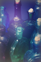 Old colourful bottles against a dark background