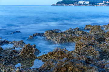 blurred waves on a rocky sea coast