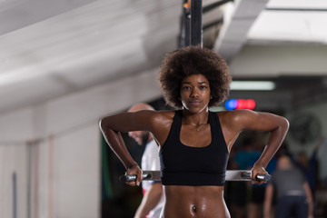 black woman doing parallel bars Exercise