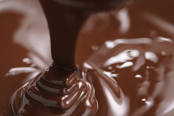 premium dark chocolate pour in bowl, shallow focus