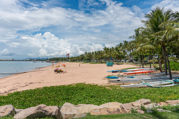 The Strand beach with lifeguard, safe swimming nets, canoes and palm trees, Townsville, Australia