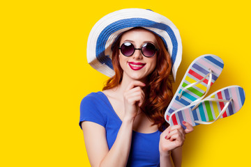 beautiful young woman with colorful sandals on the wonderful yellow background