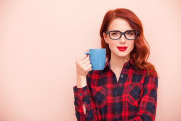 beautiful young woman with cup of coffee on the wonderful pinl background