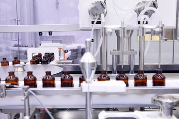 Sterile capsules for injection. Bottles on the bottling line of the pharmaceutical plant. Machine after checking sterile liquids. Interferon, nasoferon.