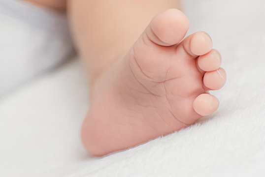 Close-up of mother hands holding tiny baby feet
