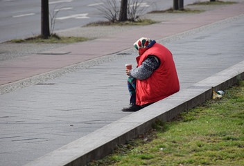Bettlerin mit roter Jacke