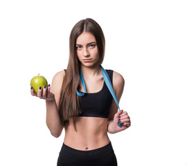 Slim and healthy young woman holding measure tape and apple isolated on white background. Weight loss and diet concept.