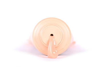 liquid make up foundation spilled out of bottle tube isolated