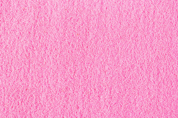 Beautiful pink decorative sand scattered on the table.