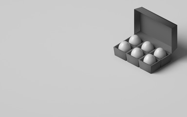 EGGS IN AN EGG BOX ON PLAIN BACKGROUND