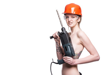 Young sexy nude woman holding a construction drill. Seductive female builder worker in hard hat and...