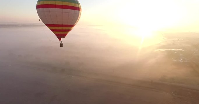 Aerial view of Hot air balloon drifting smoothly in the morning sky