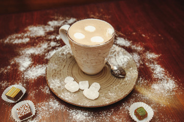 Cup hot cocoa with marshmallows, cookies on a desk with sugar powder for christmas holiday.