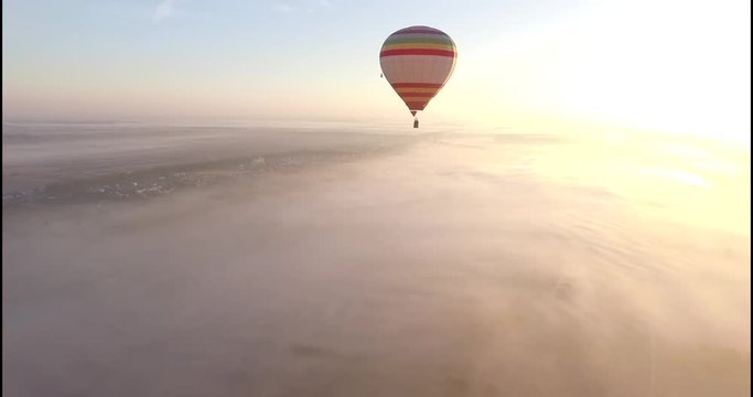 Aerial view of Hot air balloon drifting smoothly in the clear blue sky