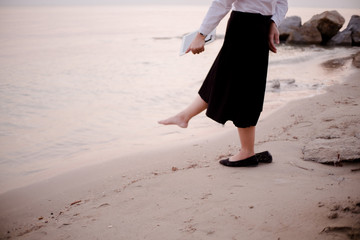 Blurred Background young business woman relaxing working Using tablet and Toe Foot touches the sea on the beach At the time of sunset . happy at work Concept .
