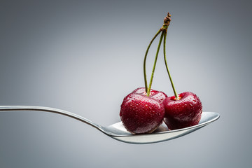 cherry on curved spoon