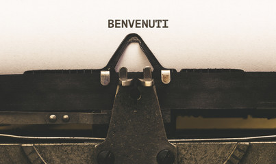 Benvenuti, Italian text for Welcome on vintage type writer from 1920s