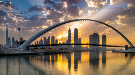 Naklejka na ściany i meble Dubai, UAE - March 4, 2017: Magical sunrise over Dubai Downtown as viewed from the Dubai water canal