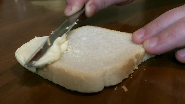 On white bread with a knife smeared with butter
