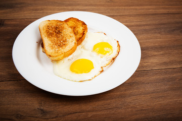 Traditional breakfast with fried eggs and toast