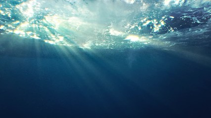Beautiful underwater sea scene view with natural light rays, shining through the water's glittering and moving surface, caustics, bubbles, and foam, perfect for background and digital composition - Powered by Adobe