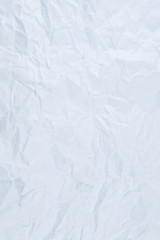 White creased paper background texture. Paper is wrinkled
